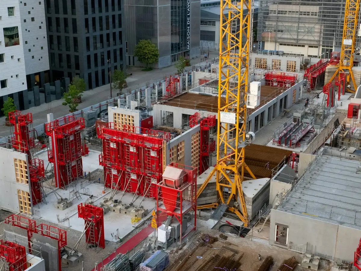 Tower cranes over a construction site in a city